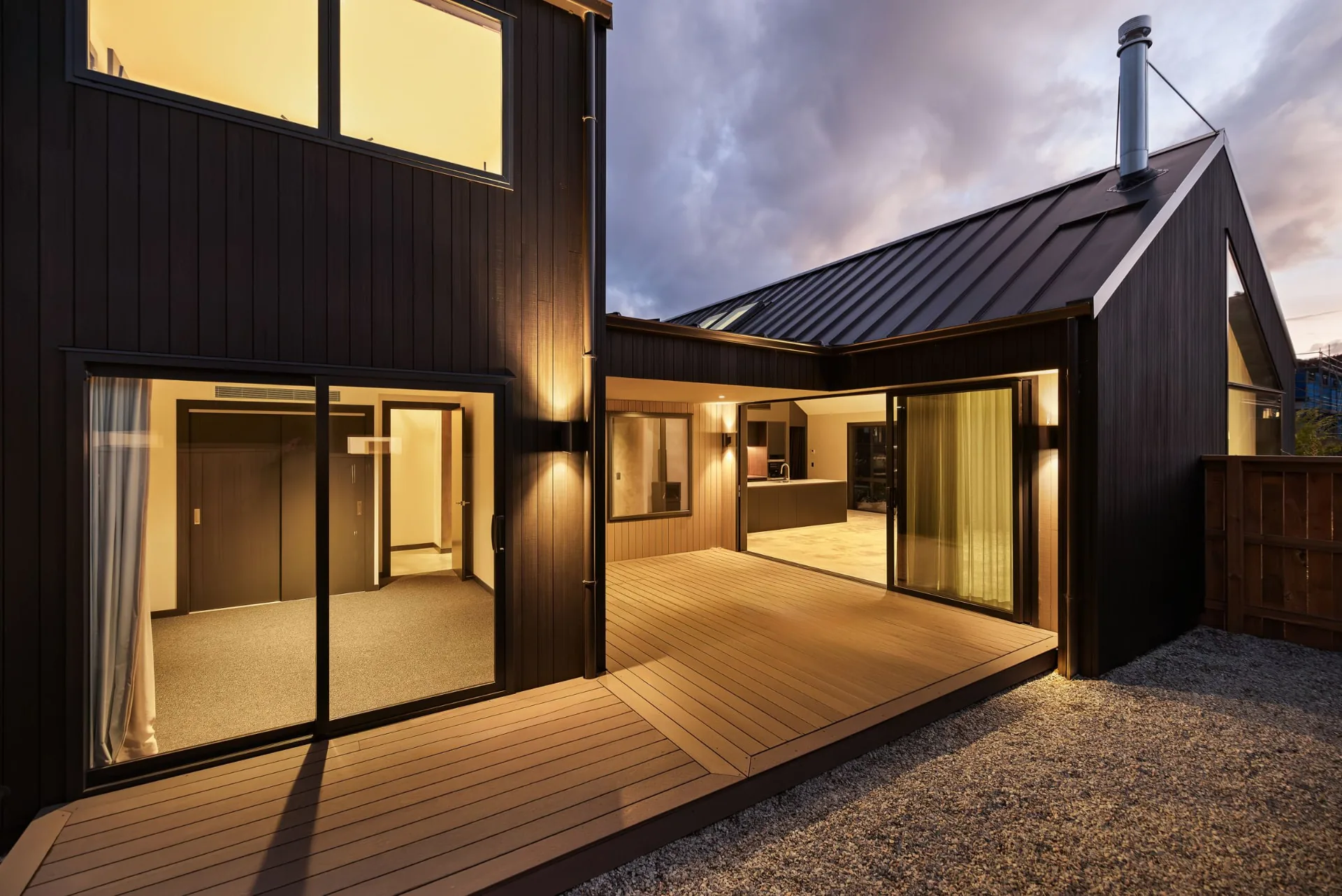 Timber deck and warmly lit rooms in the finished Drysdale Road home, Queenstown