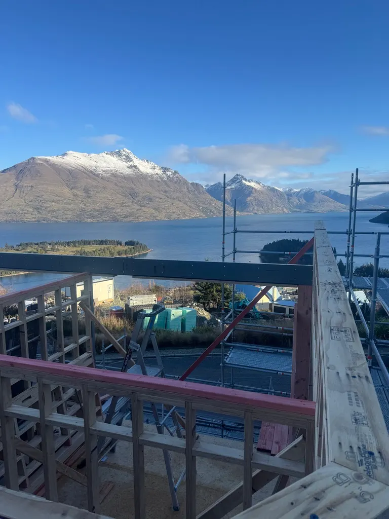 Framing at the Vancouver Drive home build with snow-capped mountain views, Queenstown