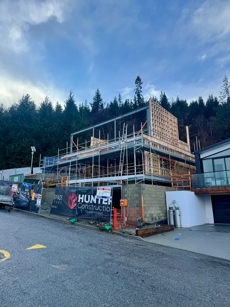 Vancouver Drive home build framing wrapped in scaffolding, Queenstown
