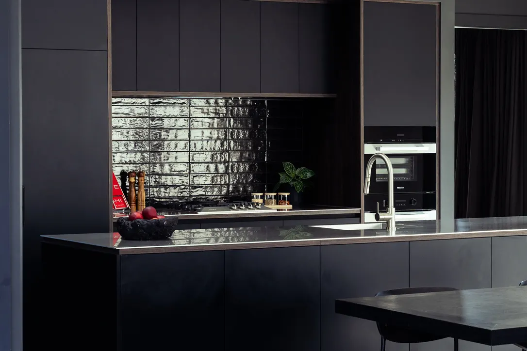 Drysdale Road black kitchen with timber joinery and gloss splashback, Queenstown